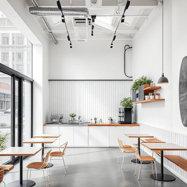 طراحی مینیمال کافه پیش‌ساخته شهری با مبلمان مدرن.